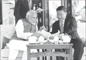  ??  ?? India’s Prime Minister Narendra Modi (left) speaks with Chinese President Xi Jinping (Reuters photo)