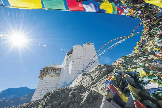  ?? Picture: Getty Images ?? CLOSER TO HEAVEN The Namgyal Tsemo Gompa, a Buddhist monastery in Leh district, Ladakh, surrounded by Tibetan prayer flags, sits high on a mountain ridge.