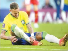  ?? EPA-Yonhap ?? Brazilian forward Neymar holds his right ankle during the 2022 Qatar World Cup group stage match against Serbia at Lusail Stadium in Lusail, Nov. 24.