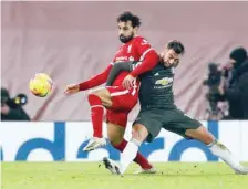  ?? — Reuters ?? Liverpool’s Mohamed Salah in action with Manchester United’s Bruno Fernandes.