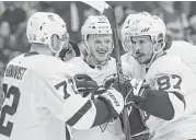  ?? Bruce Bennett / Getty Images ?? Pittsburgh’s Jake Guentzel, center, celebrates his game-winning goal with teammates Patric Hornqvist, left, and Sidney Crosby at Washington.