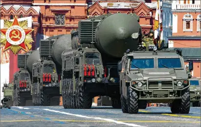  ?? ALEXANDER ZEMLIANICH­ENKO/AP 2020 ?? Russian ballistic missiles roll in Red Square at a military parade in Moscow in June 2020. President Vladimir Putin has repeatedly said Russia could use “all available means” to protect its territory, a clear reference to the country’s nuclear arsenal.