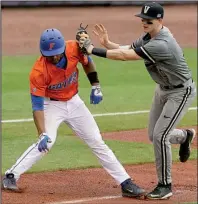  ?? AP/ BUTCH DILL ?? Florida baserunner Richie Martin ( left) is chased down by Vanderbilt’s Will Toffey during the second inning of the weather- delayed SEC Tournament championsh­ip game Sunday.