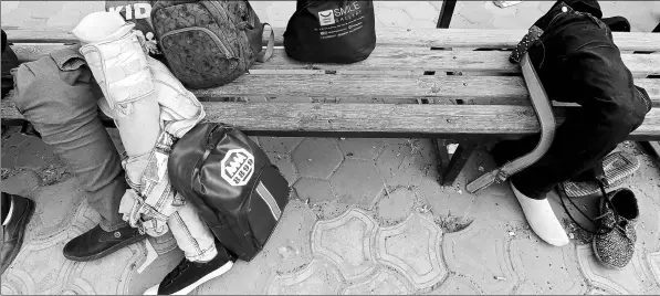  ?? REUTERS ?? Prosthetic legs are left behind on a bench during a Miracle Team training session. Finding pitches to play on and a lack of funding have proven a challenge for the players.