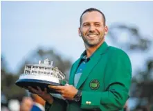  ?? THE ASSOCIATED PRESS ?? Sergio Garcia, of Spain, holds his trophy at the green jacket ceremony after the Masters golf tournament Sunday.