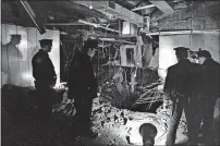  ??  ?? In this Feb. 27, 1993, file photo, Port Authority and New York City Police officers view the damage caused by a truck bomb that exploded in the garage of New York's World Trade Center the previous day. Decades after going to prison, some of the men responsibl­e for the World Trade Center bombing that killed six people 28 years ago Friday, Feb. 26, 2021, are still trying to whittle down their onetime life sentences on the remote chance that they could someday be freed. [AP PHOTO/RICHARD DREW, FILE]