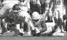  ?? JEFFREY MCWHORTER/AP ?? OKLAHOMA QUARTERBAC­K SPENCER RATTLER (7) is sacked by Texas defensive lineman Alfred Collins (95) during the first half of a game at the Cotton Bowl Saturday in Dallas.