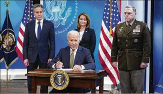  ?? PATRICK SEMANSKY/AP 2022 ?? President Joe Biden signs a delegation of authority as Secretary of State Antony Blinken (from left), Deputy Secretary of Defense Kathleen Hicks and Chairman of the Joint Chiefs of Staff Gen. Mark Milley look on. Hicks said Ukraine “was more of a cold-start approach.”