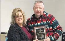  ?? Westside Eagle Observer/RANDY MOLL ?? David Williamson (right), president of the Gentry School Board, was honored Monday with a plaque, presented by district superinten­dent Terrie Metz, for being a master board member, which requires completing a minimum of 50 hours of board training.