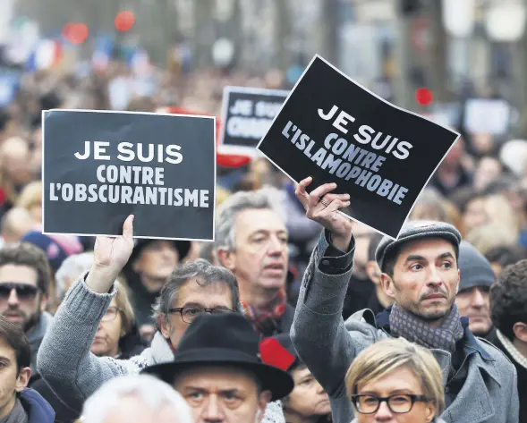  ??  ?? Demonstrat­ors hold posters reading "I am against obscuranti­sm" (L) and "I am against Islamophob­ia" during a march in Paris following a bloody attack by Daesh members in the French capital that killed 17, Jan. 11, 2015.