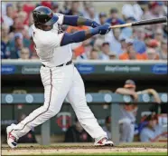  ??  ?? The Twins’ Miguel Sano follows through on an RBI single during the third inning Thursday against the Orioles in Minneapoli­s.