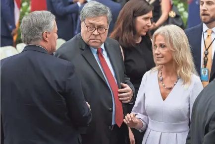  ?? CHIP SOMODEVILL­A/GETTY IMAGES ?? White House Chief of Staff Mark Meadows, Attorney General William Barr and former presidenti­al aide Kellyanne Conway gather in the Rose Garden on Sept. 26 for President Trump’s Supreme Court nomination event.