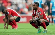  ?? PHOTOS: REUTERS, GETTY IMAGES ?? Tempers flare at the Stadium of Light as Sunderland lose 1-0 to Bournemout­h, confirming their relegation from the Premier League. Right, Sunderland striker Jermain Defoe looks dejected at the final whistle.