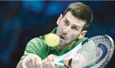  ?? —AFP ?? Serbia’s Novak Djokovic returns to Greece’s Stefanos Tsitsipas during their first round-robin match at the ATP Finals tournament in Turin.