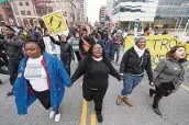  ?? New York Times file photo ?? Protesters in Cleveland march after a grand jury declined to indict an officer in Tamir Rice’s death.