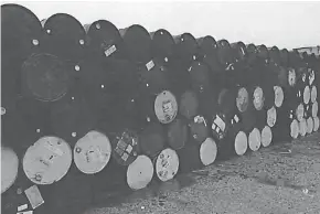  ?? RESOURCES WISCONSIN DEPARTMENT OF NATURAL ?? Fifty-five-gallon drums are seen stored in a parking lot outside the Mid-America Steel Drum plant in St. Francis during a safety inspection of the facility.