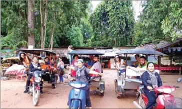  ?? SUPPLIED ?? Some of the members of the Driver Srey team posing with their rides in Siem Reap province.