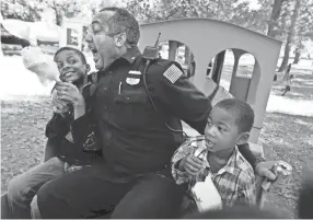  ?? THE COMMERCIAL APPEAL FILES ?? Oct. 18, 2015: Mpdofficer Joseph Majors makes a move on Ayden Aughtry’s cotton candy at Audubon Park