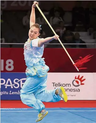  ??  ?? Serious business: Phoon Eyin in action during the women’s qiangshu routine in Kemayoran yesterday.