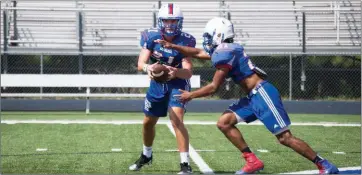  ?? PHOTOS BY MORGAN ACUFF/CONTRIBUTI­NG PHOTOGRAPH­ER ?? Arkadelphi­a quarterbac­k Cannon Turner hands the ball off to running back Zion Hatley during practice.