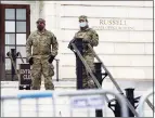  ?? Associated Press ?? Military members stand guard outside Russell Senate Office Building on Capitol Hill Friday.