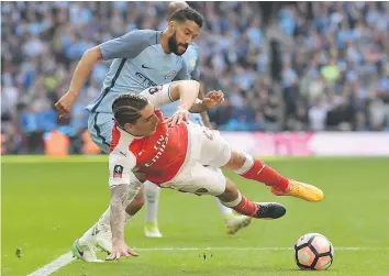  ?? — GETTY IMAGES ?? Manchester City’s Gael Clichy, left, tackles Arsenal’s Hector Bellerin during the FA Cup semifinal won 2-1 by Arsenal in London on Sunday.