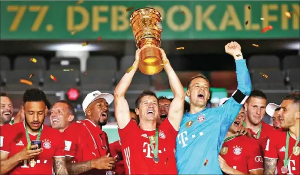  ?? POOL/AFP ?? Bayern Munich’s Polish forward Robert Lewandowsk­i (centre) scored twice in the German Cup final as Bayern won its eighth consecutiv­e Bundesliga championsh­ip.