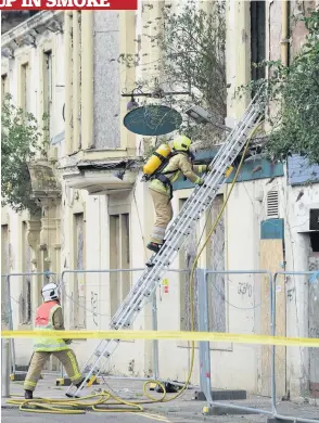  ??  ?? Grim Firefighte­rs worked hard to make the building safe