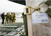  ?? MICHAEL CONROY/AP ?? Agricultur­e Secretary Tom Vilsack, left, greets crew members of a plane that delivered infant formula Sunday at Indianapol­is Internatio­nal Airport in Indianapol­is.