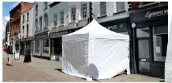  ??  ?? Hunt for clues: Tent over the front of the cafe yesterday