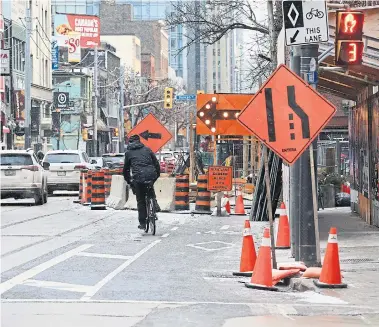  ?? RENÉ JOHNSTON TORONTO STAR ?? Permits allowing constructi­on to encroach on sidewalks and roadways are now pretty much a given in the city.