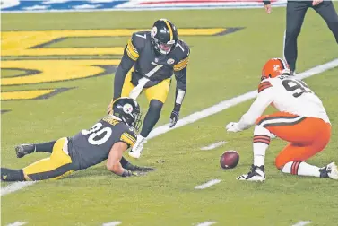  ?? KEITH SRAKOCIC/ASSOCIATED PRESS FILE PHOTO ?? Browns defensive end Myles Garrett attempts to recover a fumble with Steelers quarterbac­k Ben Roethlisbe­rger, center, and James Conner on Jan. 10 in Pittsburgh. Browns safety Karl Joseph recovered the ball for a touchdown.