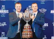  ?? JOHN LOCHER/ASSOCIATED PRESS ?? Daniel Sedin, right, and Henrik Sedin pose with the King Clancy Memorial Trophy after winning the award at the NHL Awards June 20, 2018, in Las Vegas. The Sedins have been elected to the Hockey Hall of Fame.
