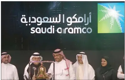  ?? (AP/Amr Nabil) ?? Stock market and Saudi Aramco officials celebrate in Riyadh to mark the state-owned oil company’s initial public offering in December. Saudi Aramco said Wednesday that the country’s Energy Ministry directed the company to increase its output capacity.