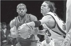  ?? NIKKI BOERTMAN, ASSOCIATED PRESS ?? Former Cleveland Cavaliers' LeBron James grabs a pass while defended by Memphis Grizzlies' Mike Miller on Jan. 15, 2008, in Memphis, Tenn. James scored 51 points in the Cavaliers' 132-124 overtime win.