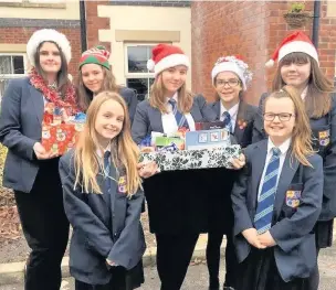 ??  ?? ●● Haslingden High School students deliver some of the Christmas hampers