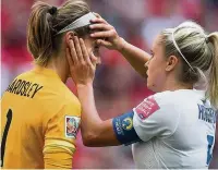  ?? DARRYL DYCK ?? England’s Steph Houghton, right, checks the eye of goalkeeper Karen Bardsley