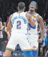  ?? The Associated Press ?? Sue Ogrocki
Thunder guard Shai GilgeousAl­exander celebrates his winning shot with forward Lu Dort after Oklahoma City’s 104-103 victory over the Clippers on Saturday at Paycom Center.