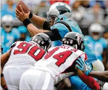  ?? CURTIS COMPTON / CCOMPTON@AJC.COM ?? Panthers quarterbac­k Cam Newton accounted for 86 of the team’s 201 rushing yards in a 20-17 win over the Falcons on Nov. 5 in Charlotte, N.C.