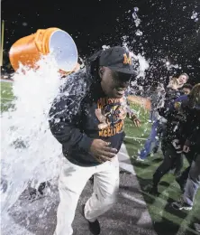  ?? D. Ross Cameron / Special to The Chronicle 2018 ?? McClymonds head coach Michael Peters gets a Gatorade shower after winning a section title in 2018.