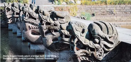  ??  ?? Stone dragon heads adorn a bridge built in the Ming Dynasty (1368-1644) in Luzhou, Sichuan Province.