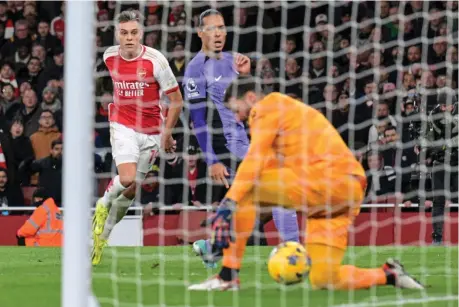  ?? KEVIN QUIGLEY ?? Nutmeg: Trossard’s shot deflects off Van Dijk and goes through Alisson’s legs to cap the win