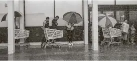  ?? Marie D. De Jesus / Houston Chronicle ?? Storm-weary shoppers wait in line to stock up on supplies at the Fiesta Mart at 7510 Bellfort on Monday.