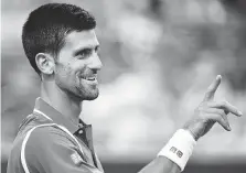  ?? THE CANADIAN PRESS ?? Novak Djokovic reacts as he plays Tomas Berdych in a men’s quarter-final match at the Rogers Cup in Toronto Friday night.