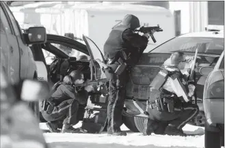  ?? Herald file photo by Ian Martens ?? Lethbridge police take cover behind a car as they work at the scene of a standoff in February on the westside.