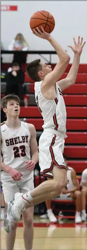  ?? CHUCK RIDENOUR/SDG Newspapers ?? Shelby’s Grant Hiatt soars through the lane for a score during last week’s game against Marion Harding as teammate Jeremy Holloway watches. The 9-1 Whippets are ranked eighth in this week’s Division II state poll.