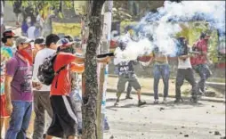  ?? AFP ?? Nicaraguan students clash with police in capital Managua during violent protests against pension reforms planned by President Daniel Ortega’s government. A journalist was shot dead while filming a confrontat­ion. At least 25 others have been killed...