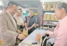  ??  ?? Azhar (left) visiting one of the booths during the Taste of Sabah launch at KKIA yesterday.