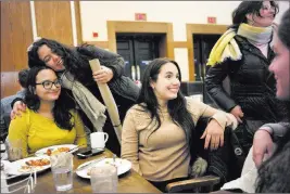  ?? Steven Senne ?? The Associated Press Brown University students from Puerto Rico, Jessica Ortiz, seated left, receives a hug from Mariana Ramos Ortiz, top left, as Fabiola Guasp, center, speaks with Coral Murphy, right, and Katerina Ramos Jordan, top right, on campus...