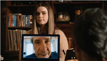  ?? APPLE TV+ PHOTOS ?? C.W. (F. Murray Abraham) attends a meeting remotely via a screen held by Jo (Jessie Ennis) in a scene from an upcoming episode of “Mythic Quest.”